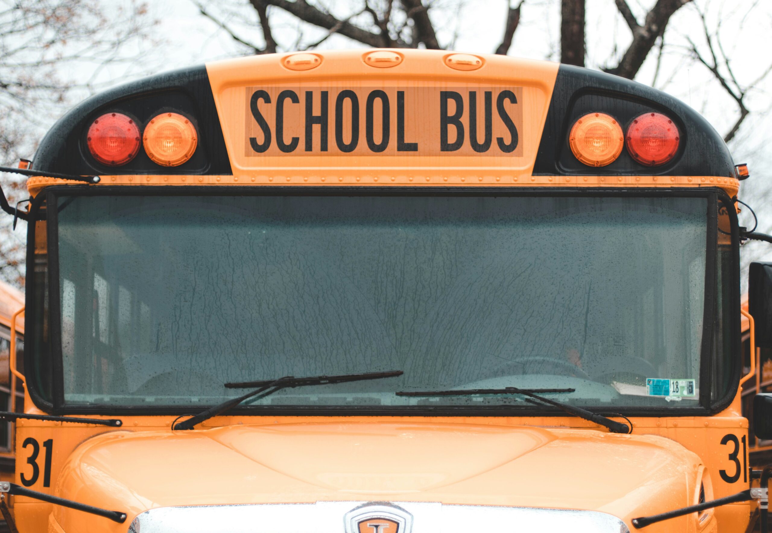 Close up of a school bus covered in rain drops.